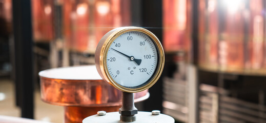 Temperature gauge in craft brewery fermentation area.