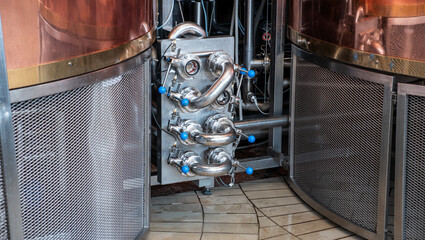 Intricate piping and pressure gauges at a small-scale brewery.