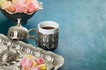 Traditional turkish coffee and turkish delight on  blue-green wooden background - 780643378