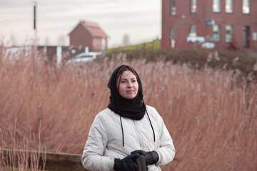 Portrait of a woman.
 A girl in a hoodie in the park