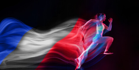 Fototapeta premium Developing speed. Young girl, professional athlete, runner in motion, training on black background with flag of France element. Professional sport, competition, tournament concept. Banner. Sport event