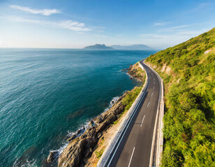 Aerial view of curved asphalt road near the ocean or sea, coastline