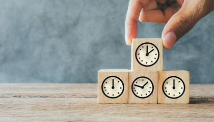 Clock icons on wooden cubes. Business time management and business plans concepts, copy space - obrazy, fototapety, plakaty