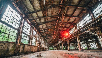 Photo sur Plexiglas Vieux bâtiments abandonnés inside a big old abandoned industrial factory with red light