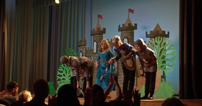 School play depicting medieval times with children in costumes on stage