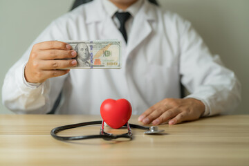 A red heart-shaped object was placed in front of the doctor..and holding money in hand The concept...