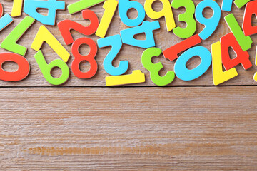 Colorful numbers on wooden table, flat lay. Space for text