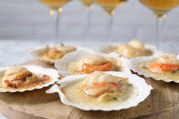 Fried scallops in shells on table, closeup