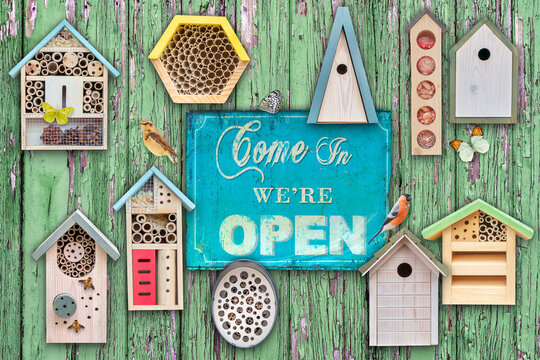 Birdhouses and insect hotels with birds and insects with welcome come in sign