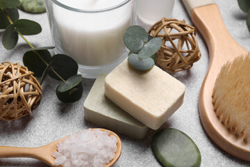 Beautiful composition with spa products and eucalyptus branches on light grey table