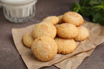 Tasty sweet sugar cookies, mint and milk on brown table, closeup