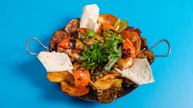 Sadj dish - Azerbaijani cuisine. Roasted chicken and vegetables in metallic pan