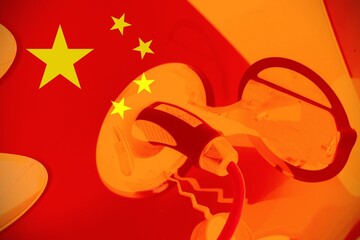 Close up view of an electric car with the Chinese flag as background. Concept of electric cars in China or Chinese car industry.