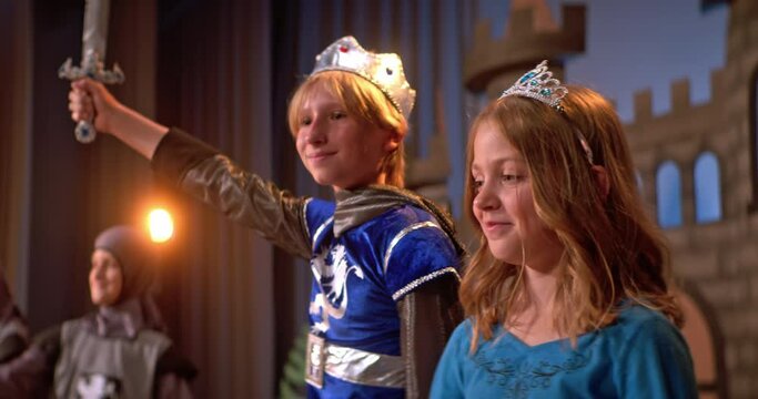 School play depicting medieval times with children in costumes on stage