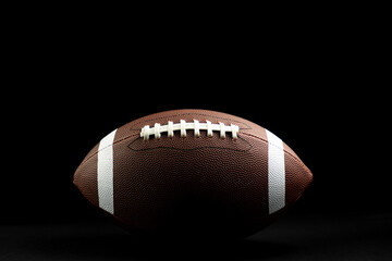 brown leather football on isolated on black background