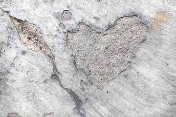 The textured cement of footpath with shape of heart,conceptual abstract background
