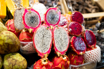 Fresh raw dragon fruit on open market. Healthy and food concept. Tropical fruits display at a...