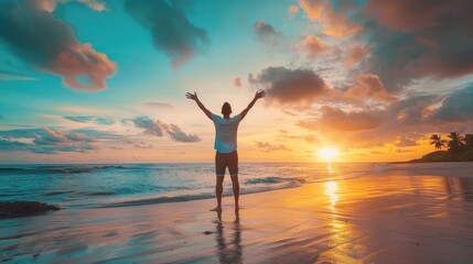 Happy man with arms raised enjoying the sunset on the beach - Delighted traveler standing with arms raised looking at the morning sunrise - Self-care