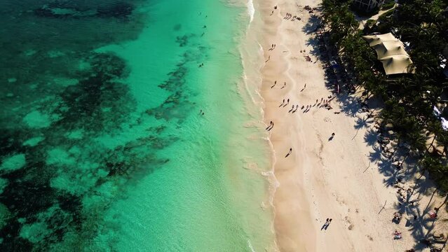 Beautiful sandy beaches in sunny Tulum in Mexico and clear blue water of the Caribbean sea close to Cancun and Playa del Carmen, a perfect vacation destination - Aerial shot drone fly by 