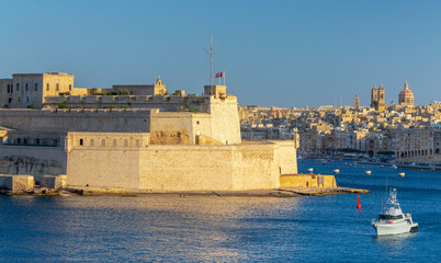 Old forts on the stone city wall above Valletta Bay.