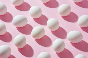 Circle of white eggs on pink background with shadows, minimalistic Easter concept, top view concept for Easter holidays