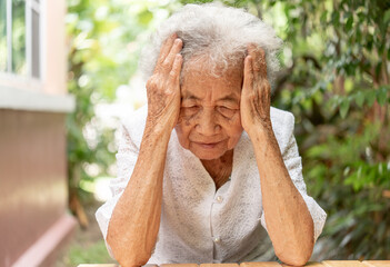 Sad senior old woman. Lonely from loss or sick with headache. Upset patient in retirement home with...