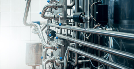 Stainless steel pipes and tanks, high-tech industrial fluid processing system. Many shiny metallic...