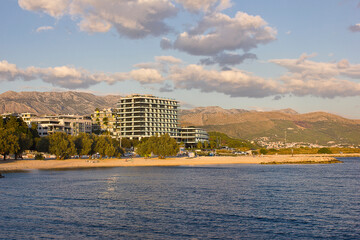 Fototapeta premium Landscape with beach and sea. Blue cloudy sky and blue sea.