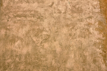 background close-up of an old, shabby beige wall