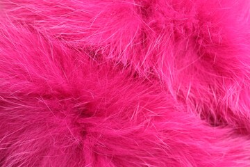 Texture of bright pink faux fur as background, closeup