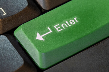 Green enter key on a computer keyboard, object macro detail extreme closeup shot, nobody. Enter key green confirmation symbol, pass mark abstract concept, no people. Acceptance, confirming, entering