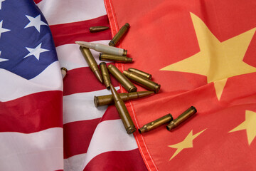 American and Chinese flags with rifle bullets scattered, the flags are slightly wrinkled.