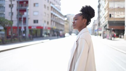 Beautiful African American mid adult woman walking through the city