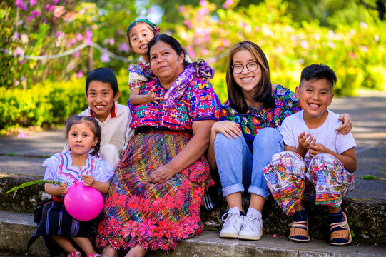 Happy grandmother with her grandchildren pose for a family portrait.