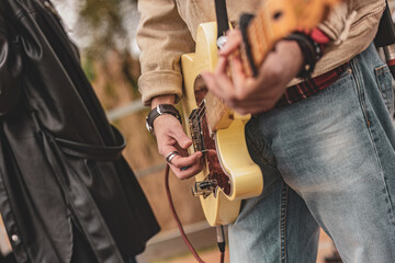 Two Men Holding Guitar - Powered by Adobe
