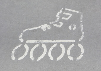 Sign of rolls on asphalt street. Safety during active resting. Marking for skaters
