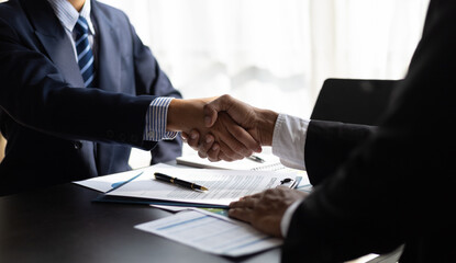 Handshake, Businessman shaking hands with partner after signing agreement contract. - obrazy, fototapety, plakaty