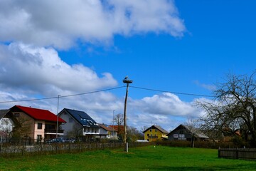 Village Dobrava pri Škocjanu with white storknesting at the top of electricity pole in Dolenjska, Slovenia