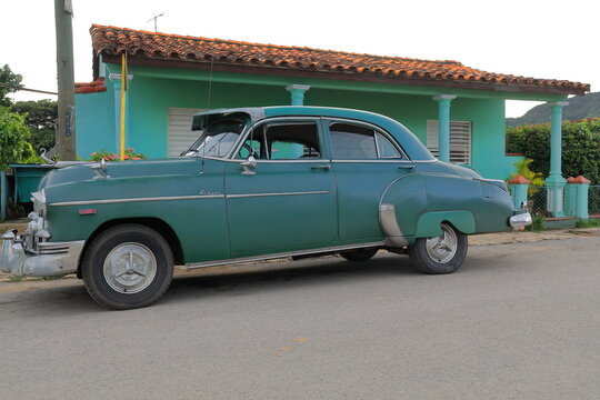 Old green almendron car -1949 Chevrolet classic- stationed on Calle Adela Azcuy Street at the beginning of sunset. Viñales-Cuba-155