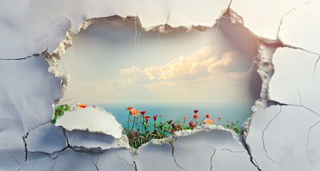 Coastal Meadow View Through Crumbled Wall. A large hole in a wall with a beautiful view of the ocean and a field of flowers