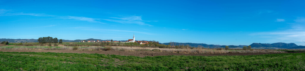 Panoramic view of a hungarian village called Csatoszeg in hungarian, Cetatuia in romanian, with the 13 century catholic church.