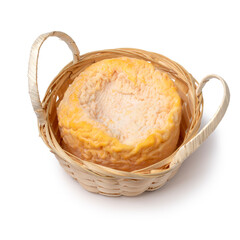 Single French Langres cheese refined with champagne in a basket close up isolated on white background