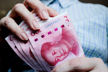 Counting yuan banknotes close up. Renminbi official currency of China. - 780726128