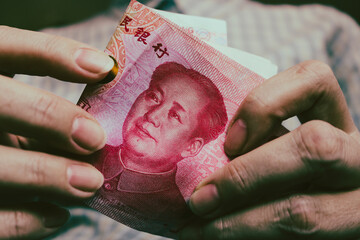 Counting yuan banknotes close up. Renminbi official currency of China.