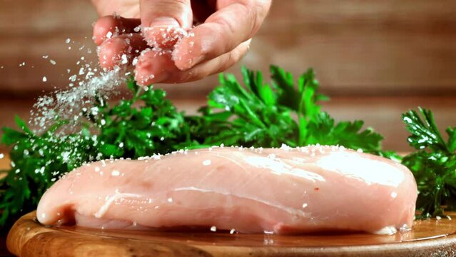 Super slow motion raw chicken fillet. High quality FullHD footage