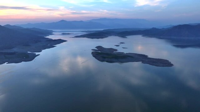 Khanpur Dam Lake Aerial Sunset View, Pakistan. Boats in water and Mountainsd on Background