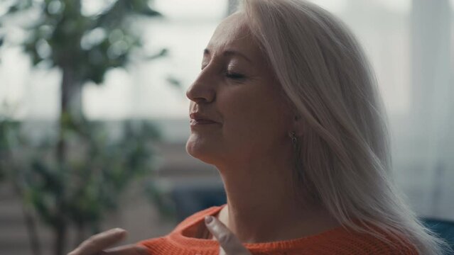 Woman in her 50s suffering from fever and sweating, menopause symptom, hormones