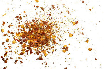 dried red chili pepper flakes and seeds isolated on white background