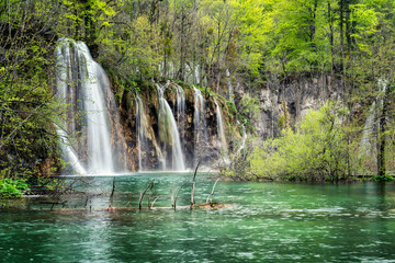 Fototapeta na wymiar Amazing picture with some of picturesque waterfalls in the green spring forest of Plitvice national park in Croatia. Plitvice lakes closer view..