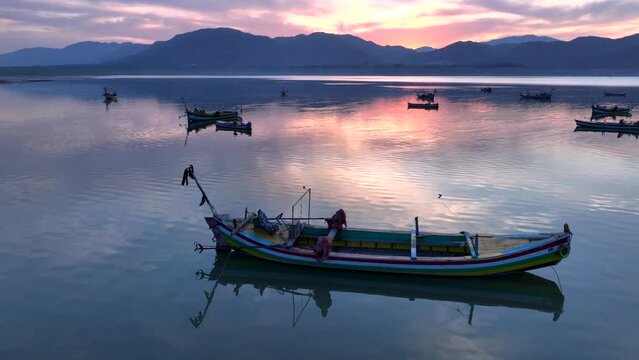 Khanpur Dam Lake Aerial Sunset View, Pakistan. Boats in water and Mountainsd on Background